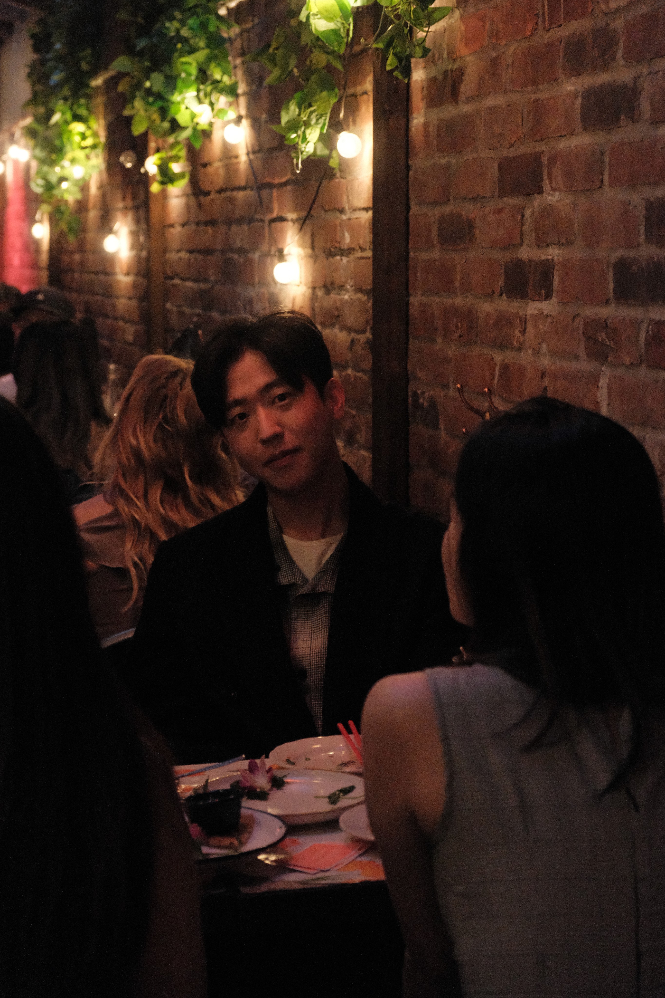 A supper club guest in conversation at dinner