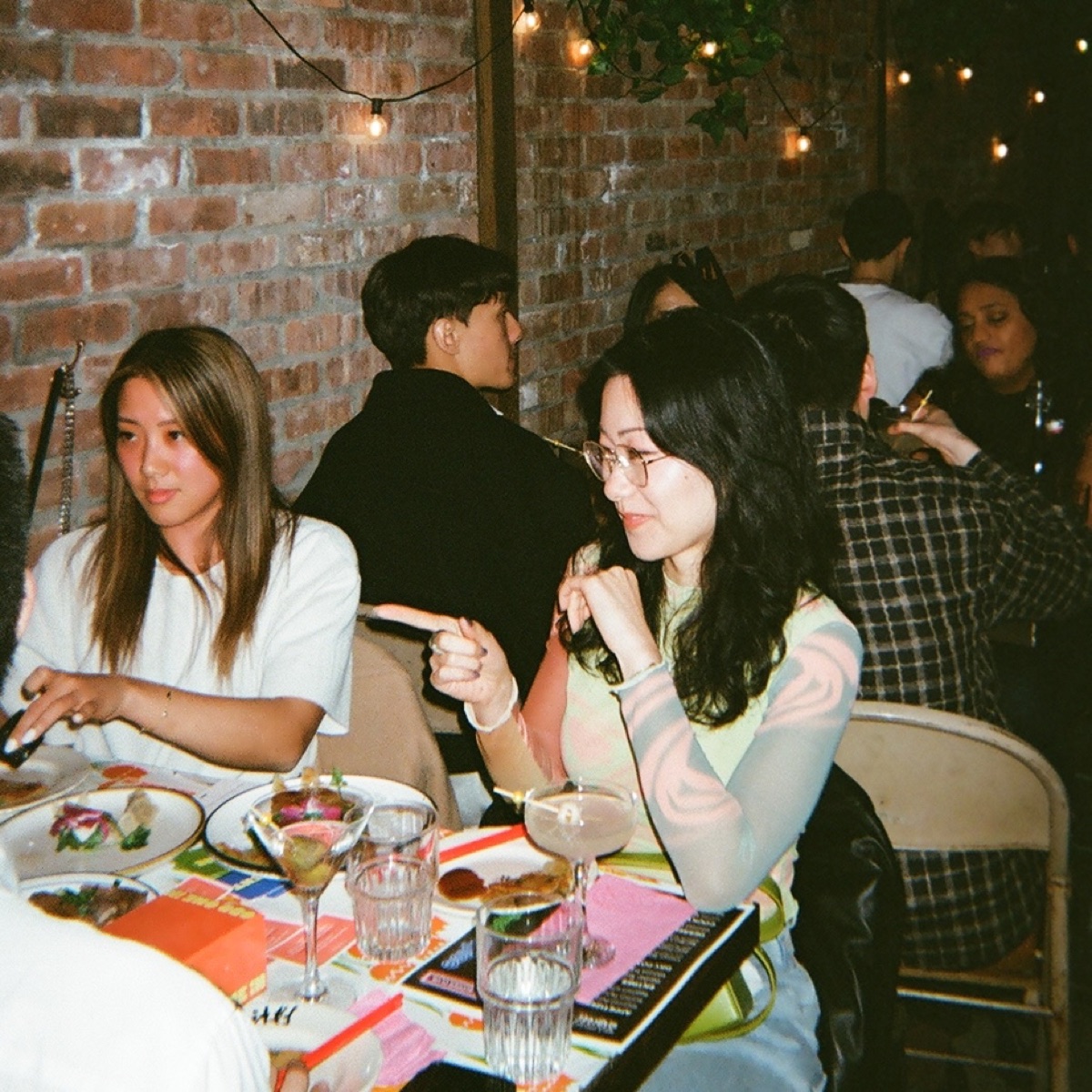 Two guests talking during supper club dinner