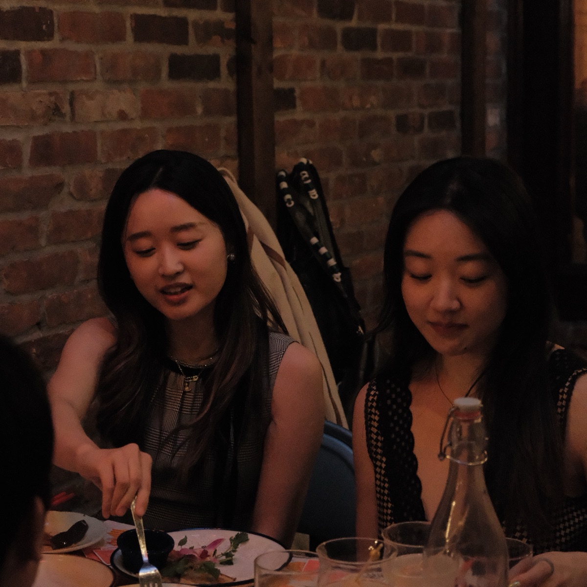Supper club guests seated by the brick wall