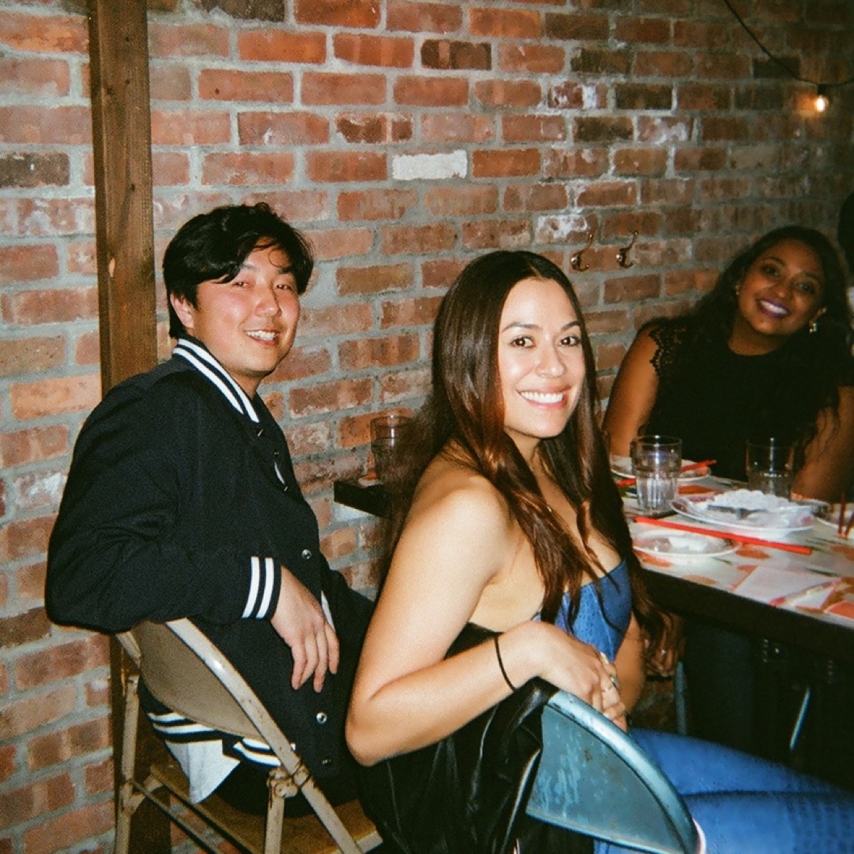 Guests smiling at a spicy supper club table