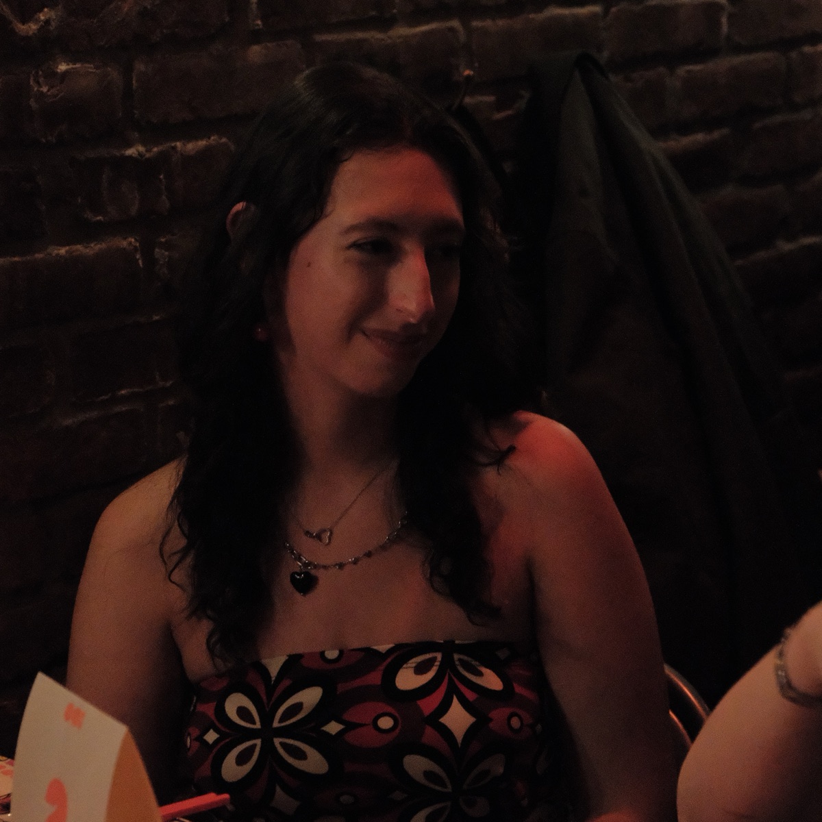 Four guests smiling around a dinner table