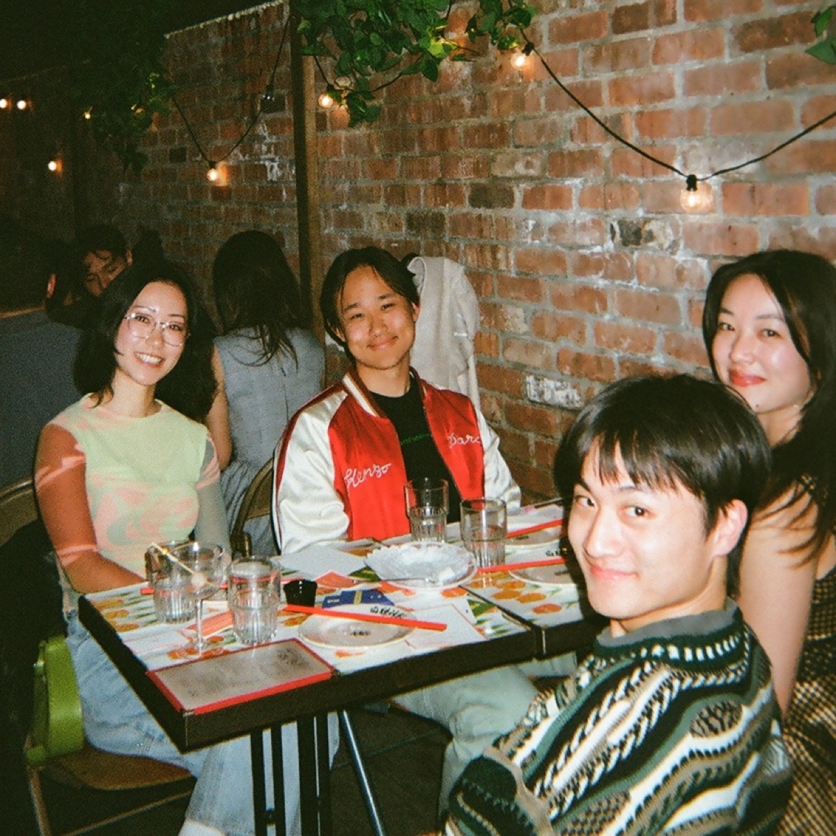 Dinner guests laughing around the table