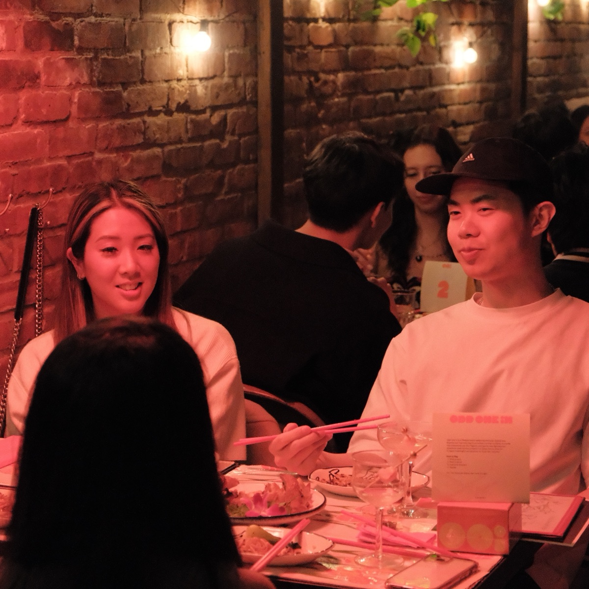 Guests talking at dinner with Odd One In bags on the table
