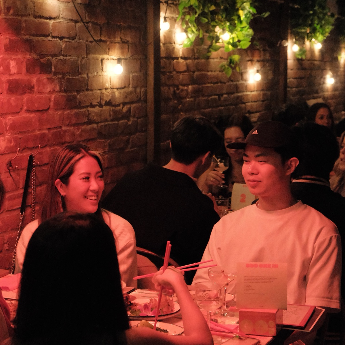 A supper club guest in conversation over dinner