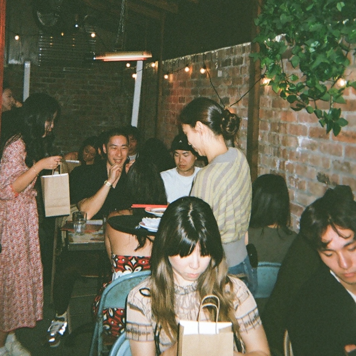 A guest smiling during a supper club conversation
