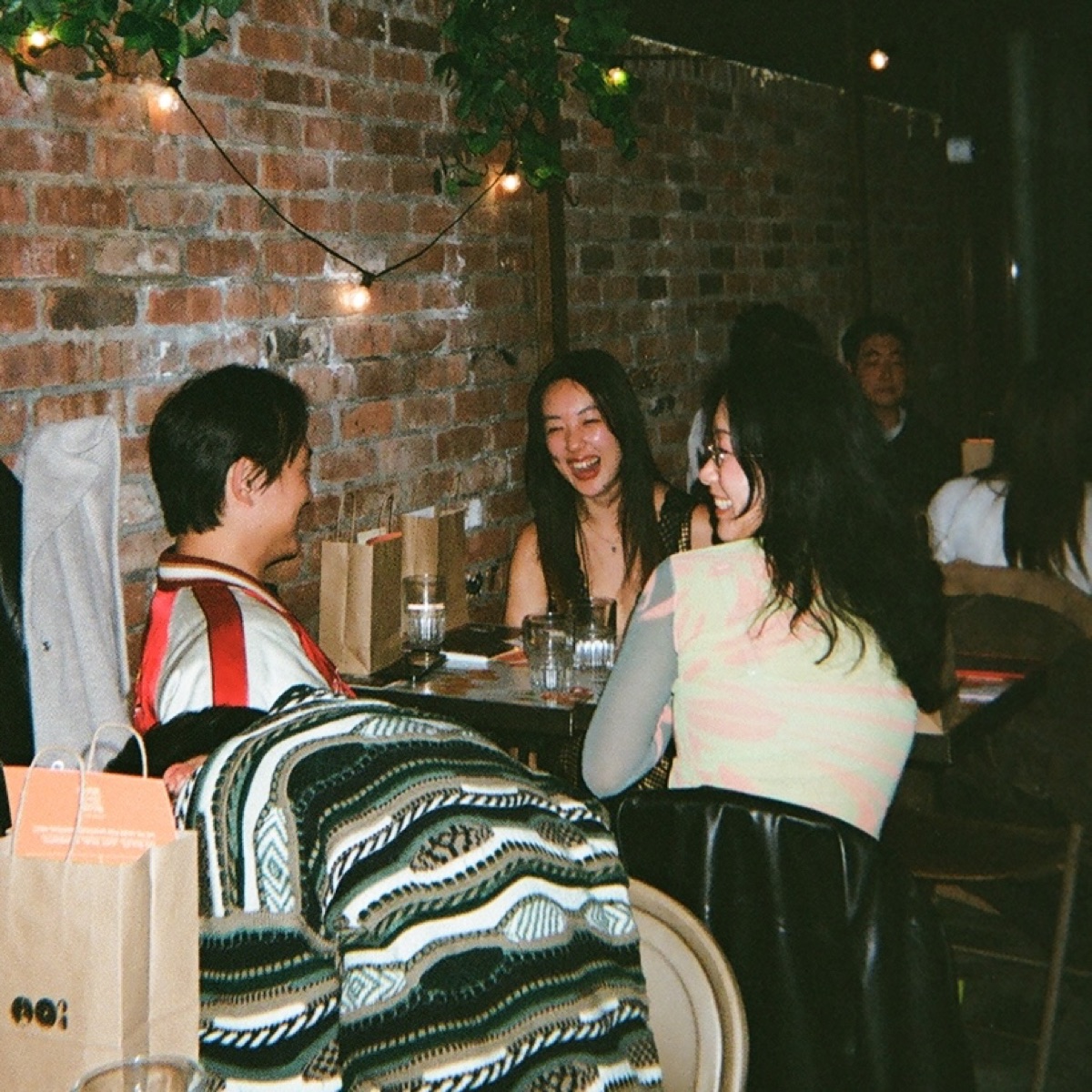 Supper club guest using chopsticks at dinner