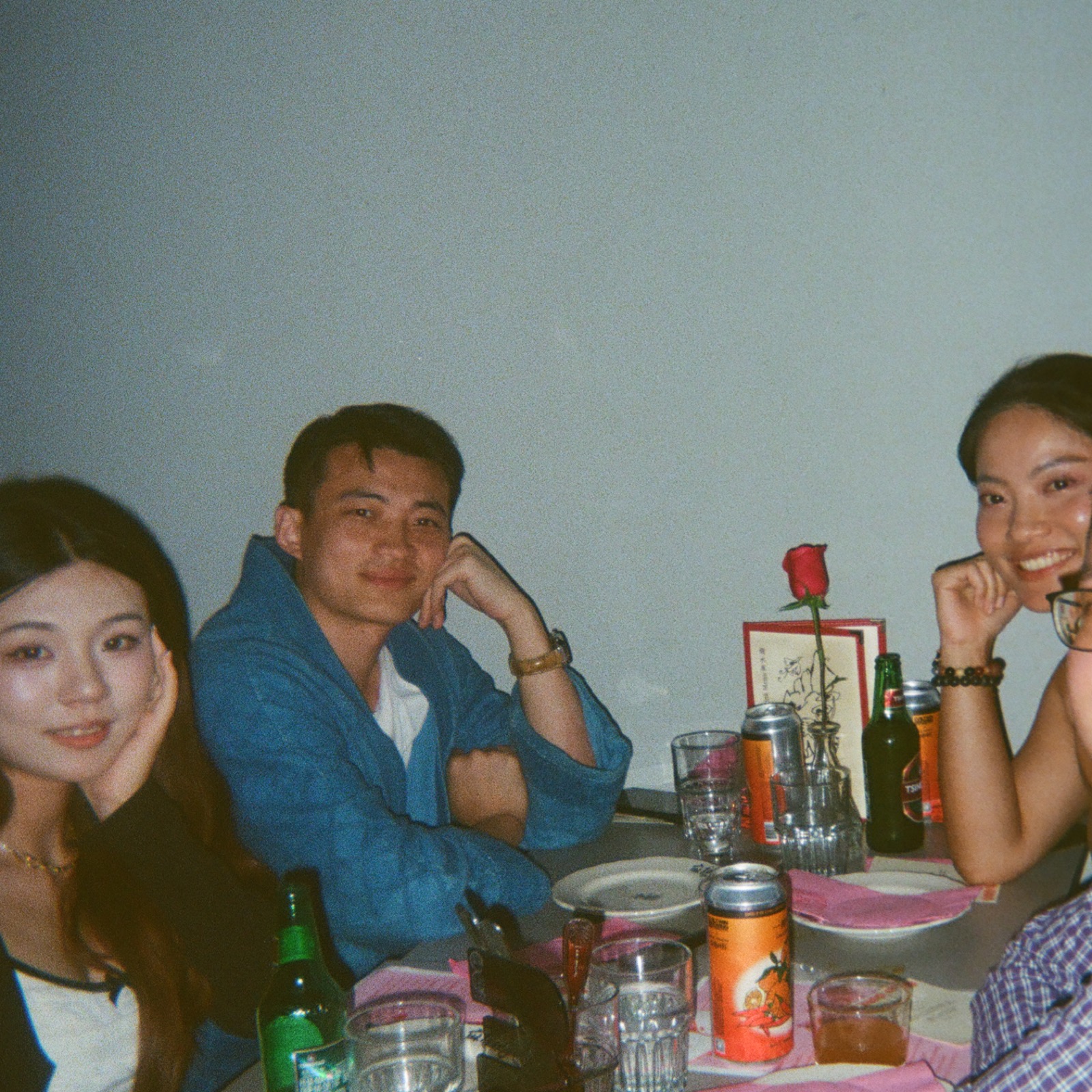 Dinner guests seated with drinks and shared dishes