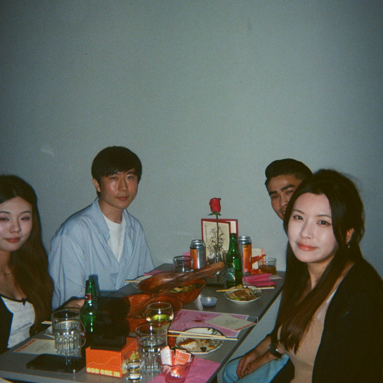 Guests smiling across the table at dinner