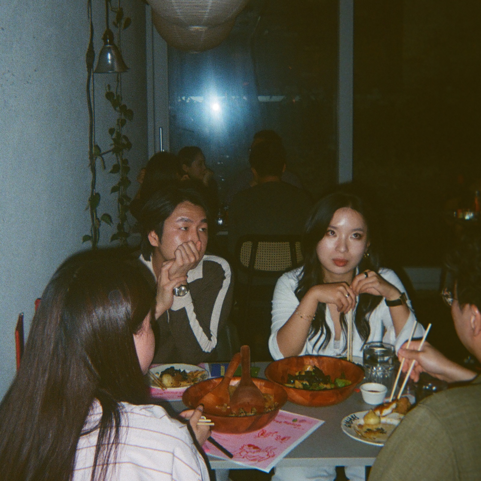 A supper club table with food, drinks, and conversation